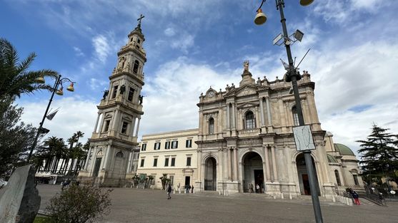 A large church with a tall bell-tower to the left of it